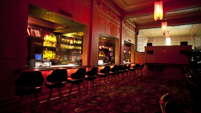 Stylish bar area in Alamo Drafthouse for networking events and cocktail receptions.