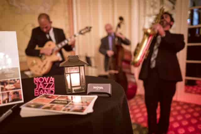 Nova Jazz Band performing in formal attire at an elegant evening event with lanterns.