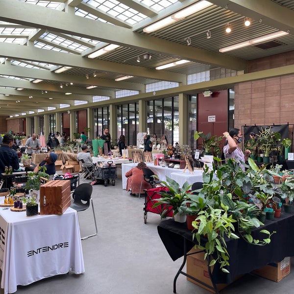 Indoor market with vendor tables for a plant-themed event in County Fair Auditorium.