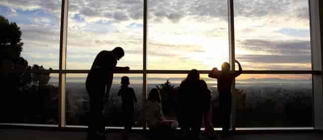 Sunset view through windows at Oakland Temple Hill Visitors' Center, ideal for events.