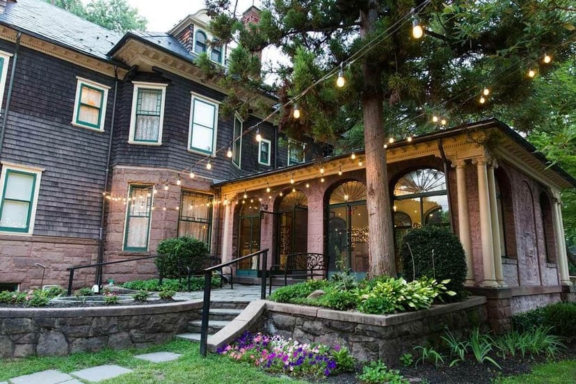 Main Building at Oakeside Mansion, historic venue with string lights for outdoor weddings.