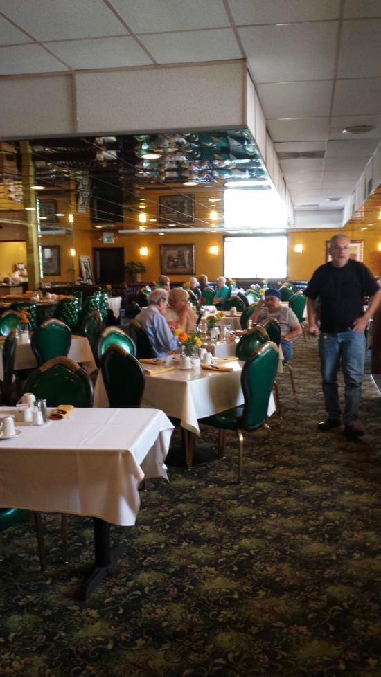 Effie's Restaurant dining room with green chairs, perfect for social events and gatherings.