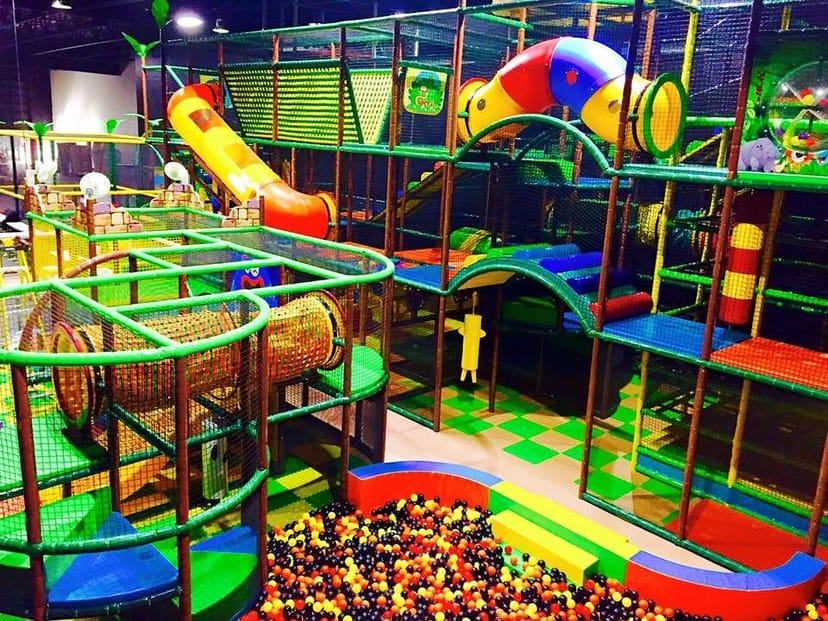 Vibrant indoor play area with colorful climbing structures for children's parties.