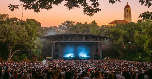 Outdoor concert at The Studio, Stanford Live, with striking stage and twilight ambiance.