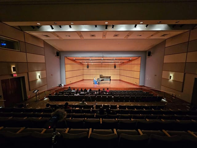 Mission Santa Clara auditorium with grand piano, perfect for concerts and events.