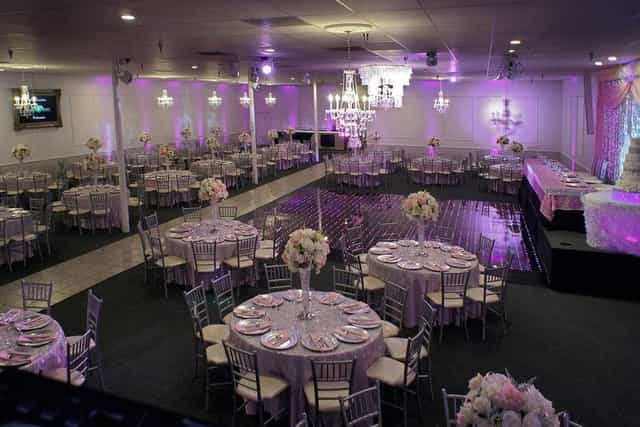Elegant banquet hall with floral centerpieces, perfect for weddings and formal events.