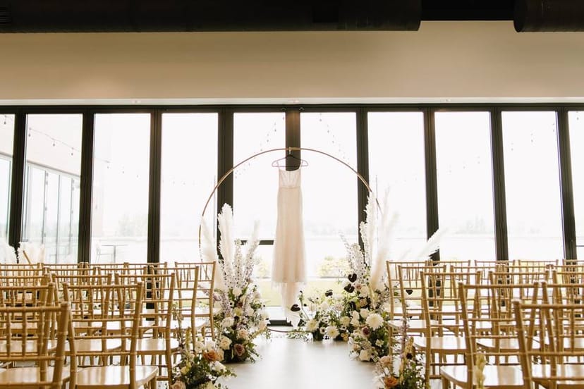 Elegant wedding ceremony setup at The Overlook, featuring floral decor and natural light.