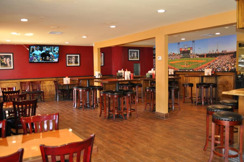 Casual event space at Grill Em Pizza & Sports Bar with sports-themed decor.