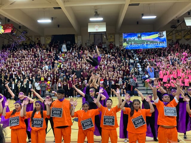Milpitas High School pep rally with enthusiastic students in coordinated outfits.