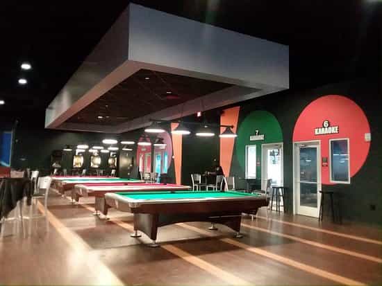 Karaoke room at Round1 USA with vibrant decor, perfect for events and team-building.