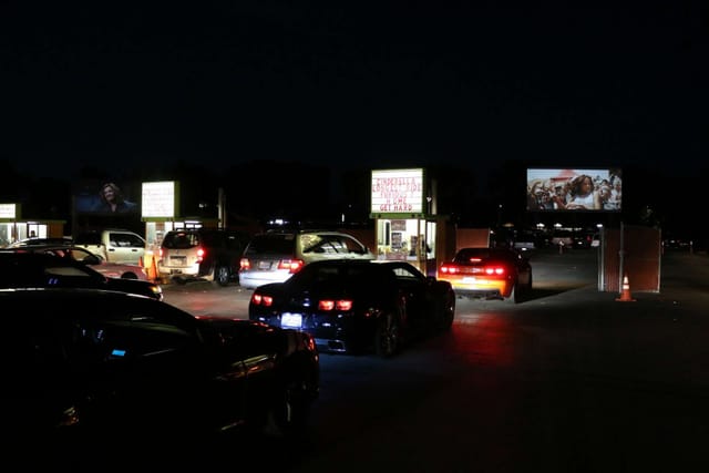 San Jose Drive-In setup with illuminated screens for safe outdoor movie nights.