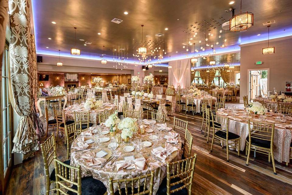 Elegant event space at The Galleria, featuring round tables and floral centerpieces.