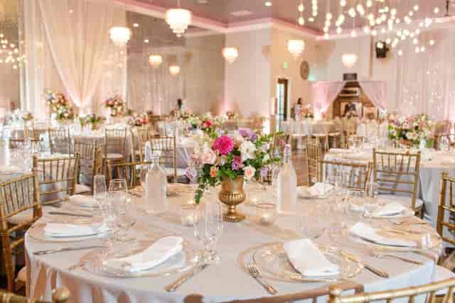 Elegant banquet hall with floral centerpieces, ideal for weddings and upscale events.
