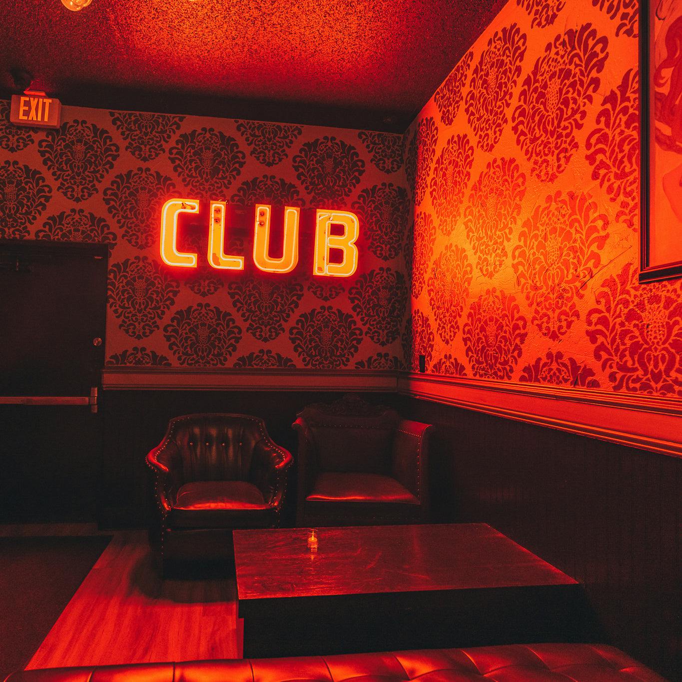 Stylish bar with warm lighting at CineLux Plaza for exclusive events and gatherings.