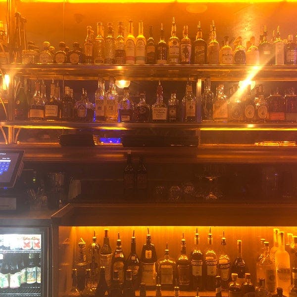 Well-stocked bar at CineLux Plaza Café, perfect for receptions and social gatherings.