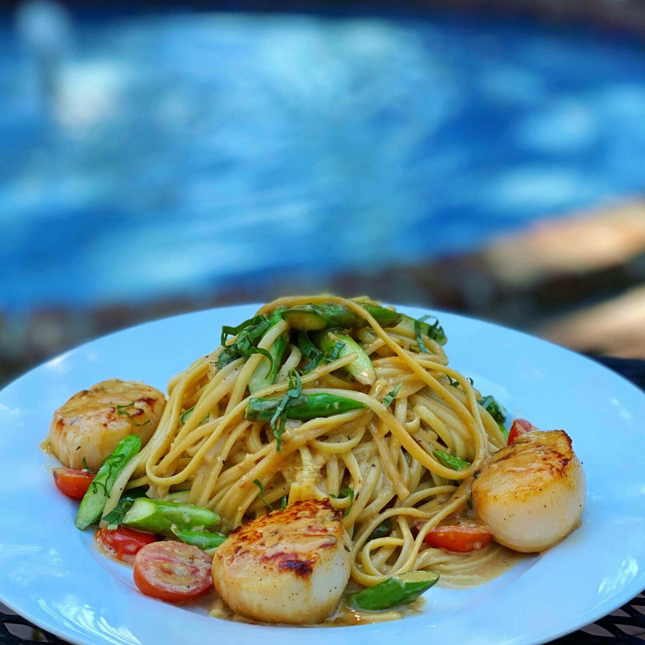 Pasta with scallops at Cafe Wisteria, upscale catering for events by serene pool.