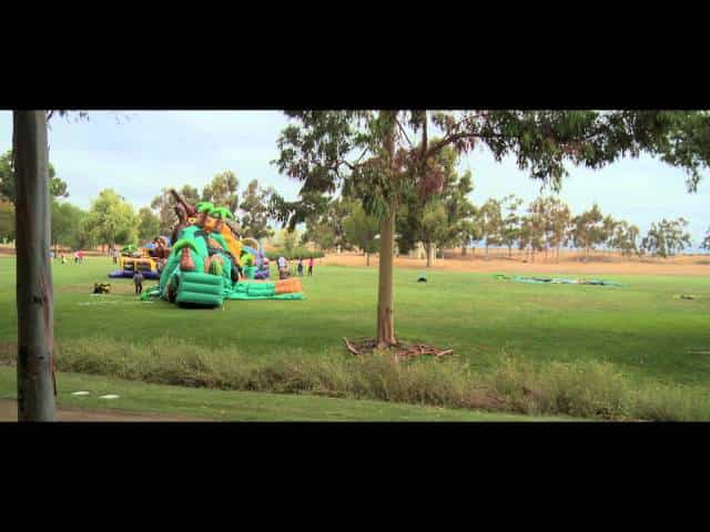Spacious outdoor venue with inflatables for family-friendly events and festivals.