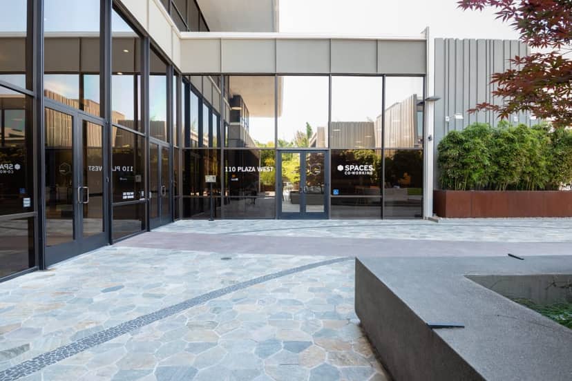 Modern coworking space entrance with glass doors, ideal for meetings and events.