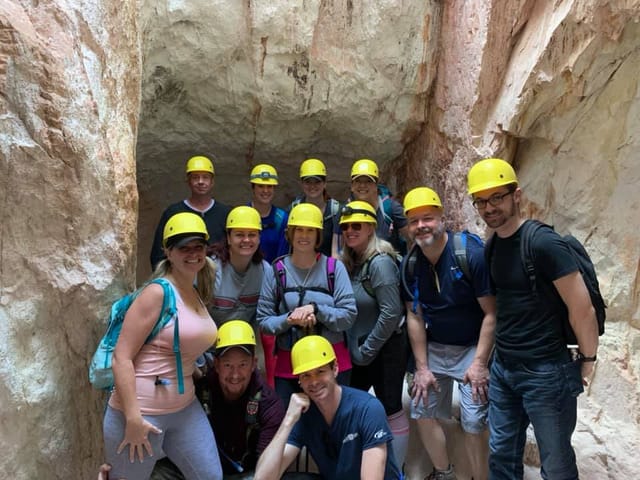Group in helmets at Santa Clara cave for adventurous team-building event.