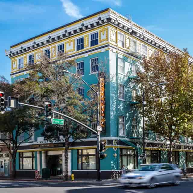 Historic Hotel Clariana with turquoise facade, perfect for events and gatherings.