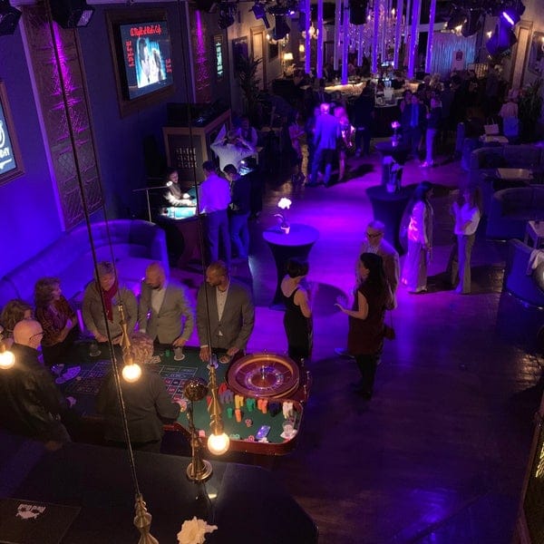 "OPAL Nightclub casino-themed event with vibrant lighting and gaming tables for social gatherings."
