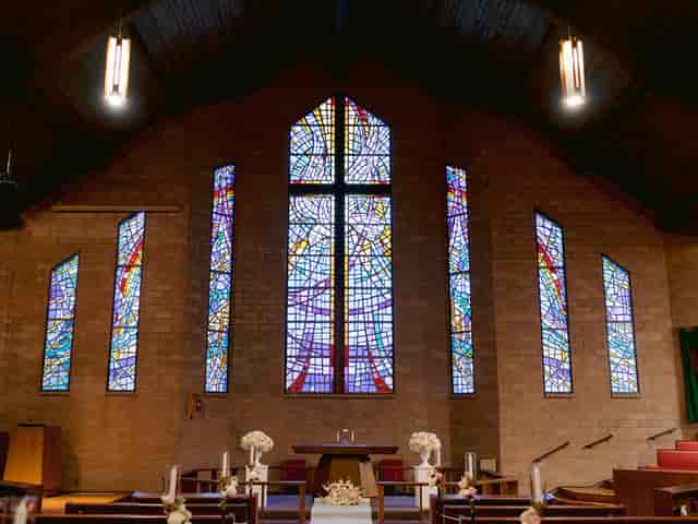 Patio at Prince of Peace Church with stained glass, ideal for weddings and events.