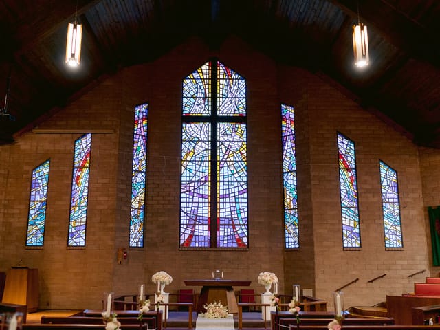 Patio at Prince of Peace Church with stained glass, ideal for weddings and events.