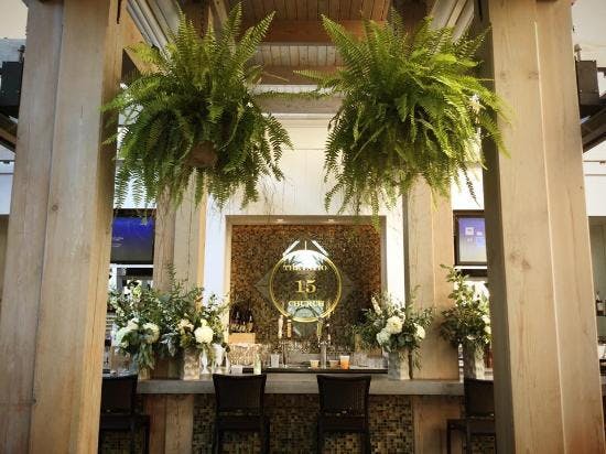 Elegant event space with stylish bar and lush greenery at Prince of Peace Church.