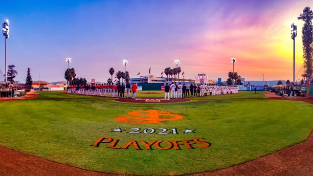 Excite Ballpark at sunset, vibrant baseball field ready for playoff game and national anthem.
