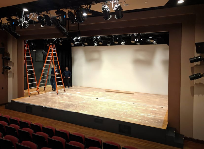 Starbright Theater auditorium stage setup with ladders for event production planning.