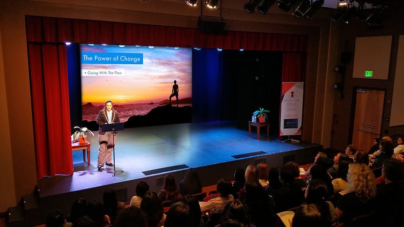 Soundstage at Starbright Theater with speaker, audience engaged in impactful event.