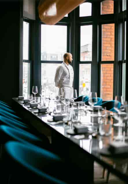 Private dining room at Alo Restaurant with a poised chef, ideal for upscale events.