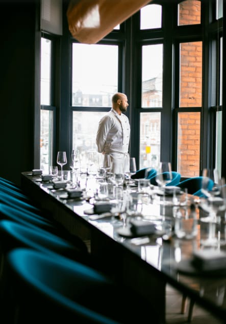 Private dining room at Alo Restaurant with a poised chef, ideal for upscale events.