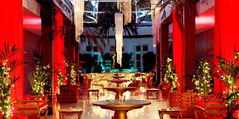 Elegant event space with red lighting at Hurlingham Yacht Club for upscale gatherings. - Banner