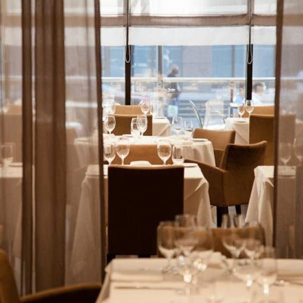 Elegant private dining room with white linens, perfect for formal events and corporate dinners.
