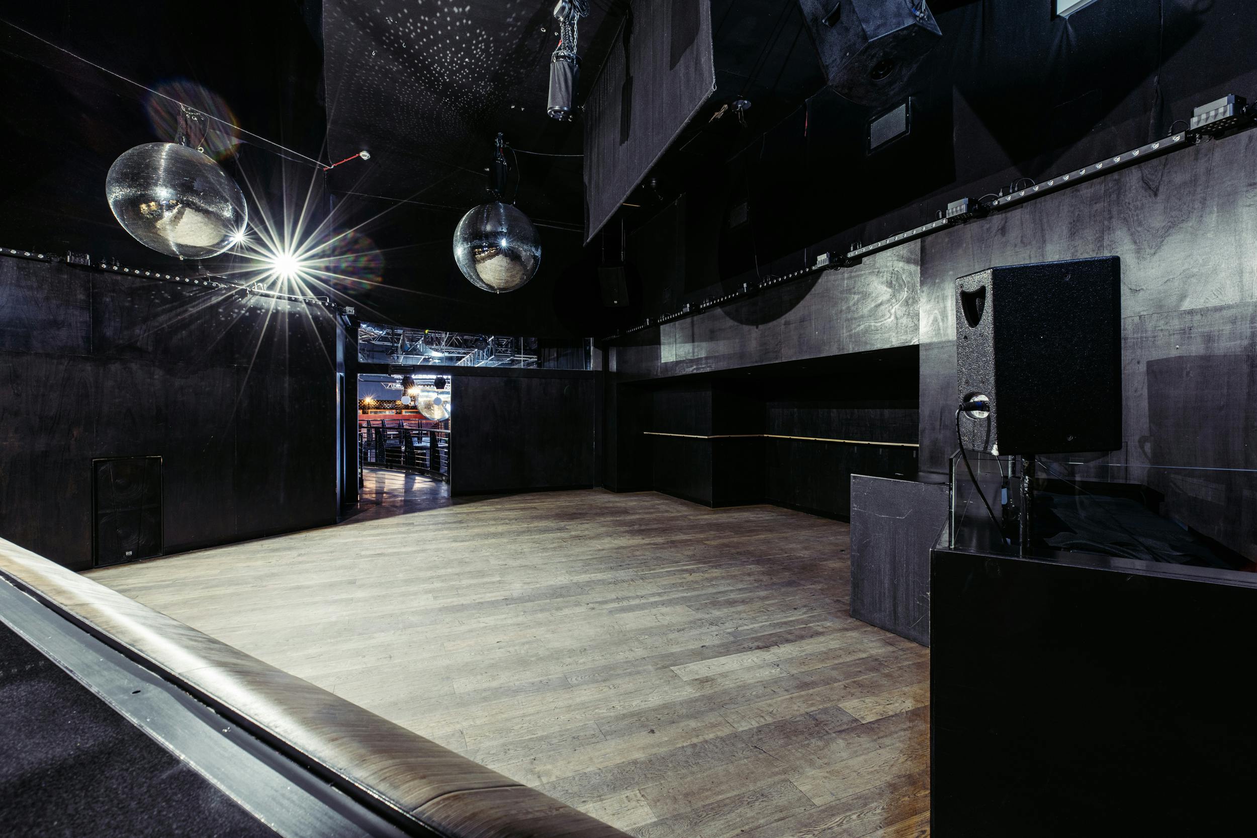 Modern event space at Ministry of Sound with disco balls for corporate and social gatherings.