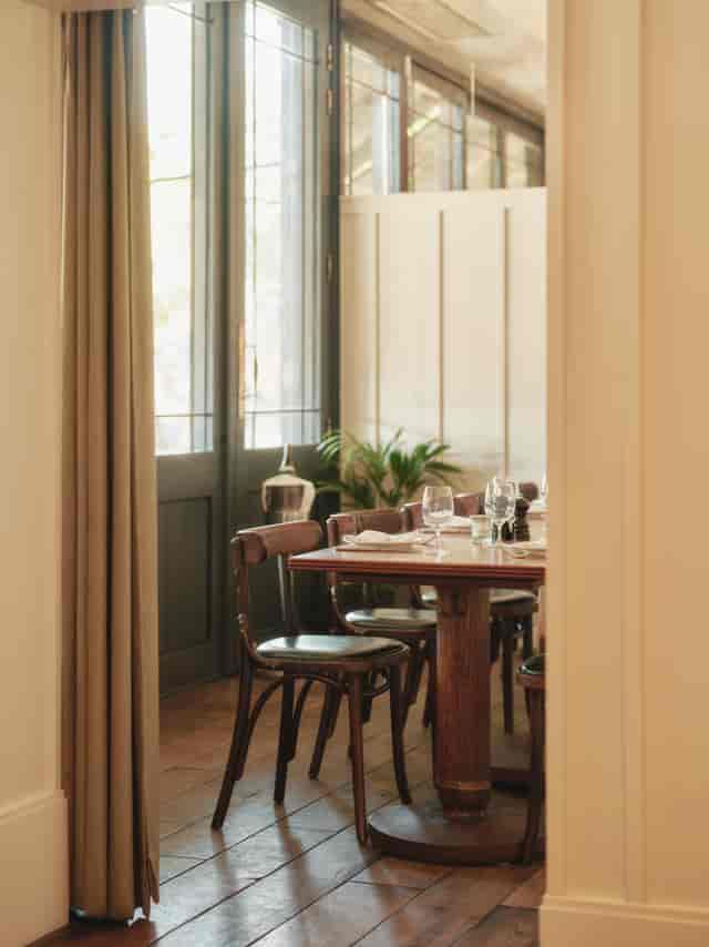 Brasserie Terrace Room dining space with wooden table, ideal for meetings and events.