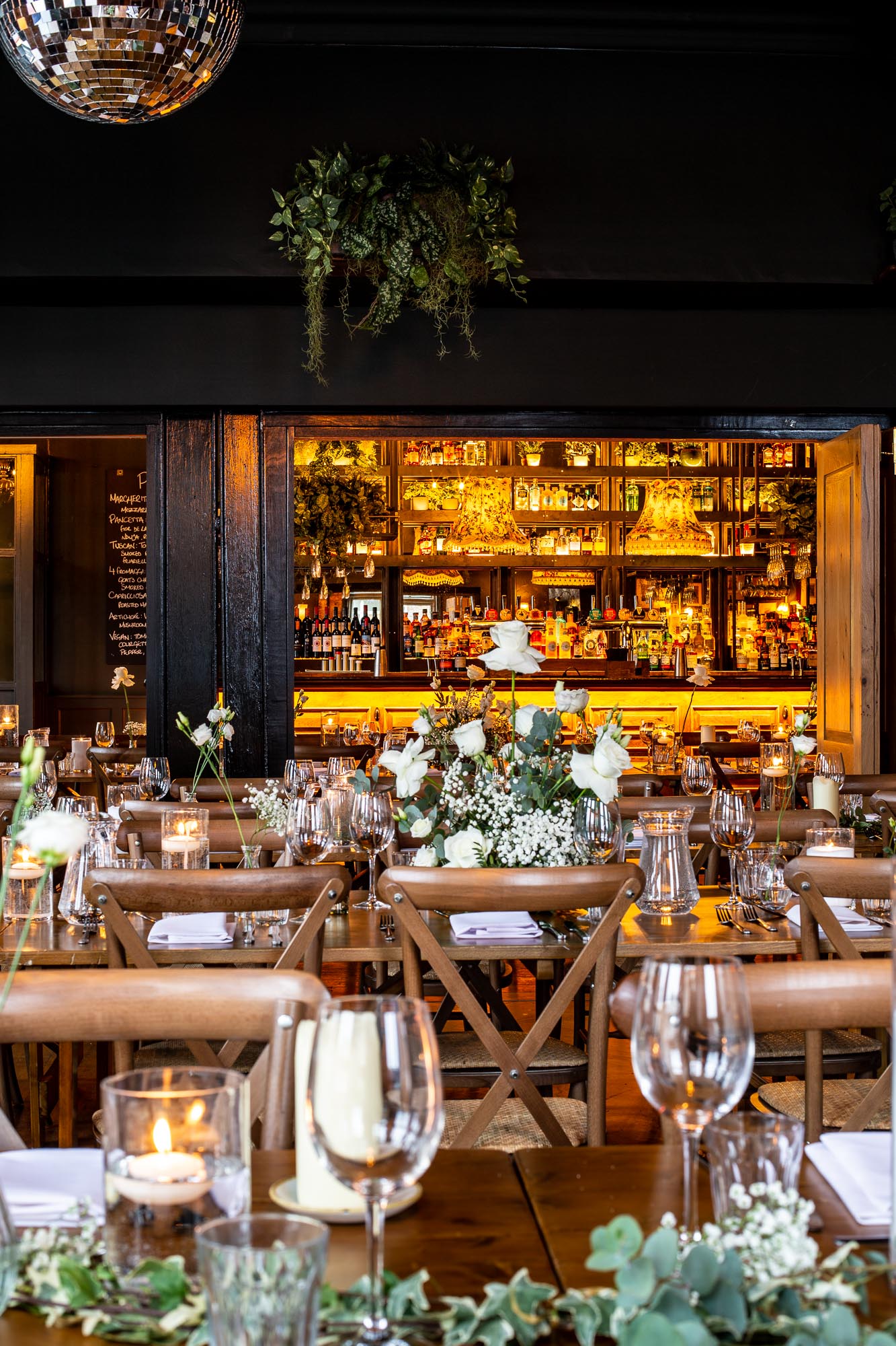 Elegant dining setup with floral centerpieces in The Railway's First Floor Lounge for events. - Banner