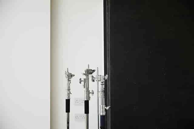Minimalist portrait studio setup with lighting stands for versatile event production.