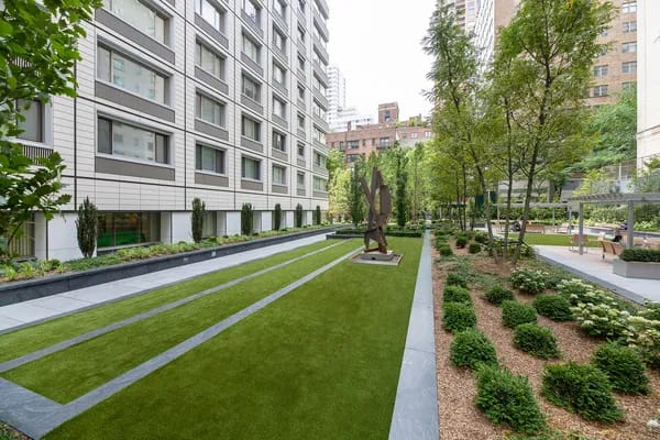 Outdoor event space with manicured lawns and sculpture for receptions or gatherings.