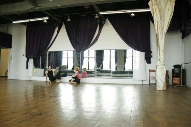 Spacious studio with polished floors for dance workshops and fitness classes.