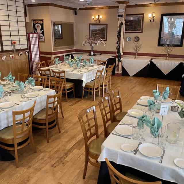 Large spacious room with elegant dining setup for corporate events and gatherings.