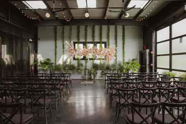 Stylish event space at 501 Union with black chairs and floral decor for gatherings.