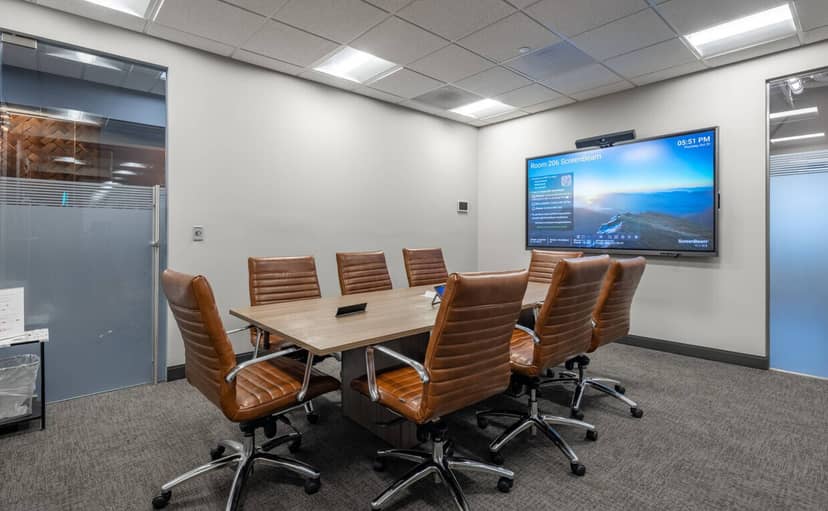 Modern conference room with large table, ideal for corporate meetings and presentations.