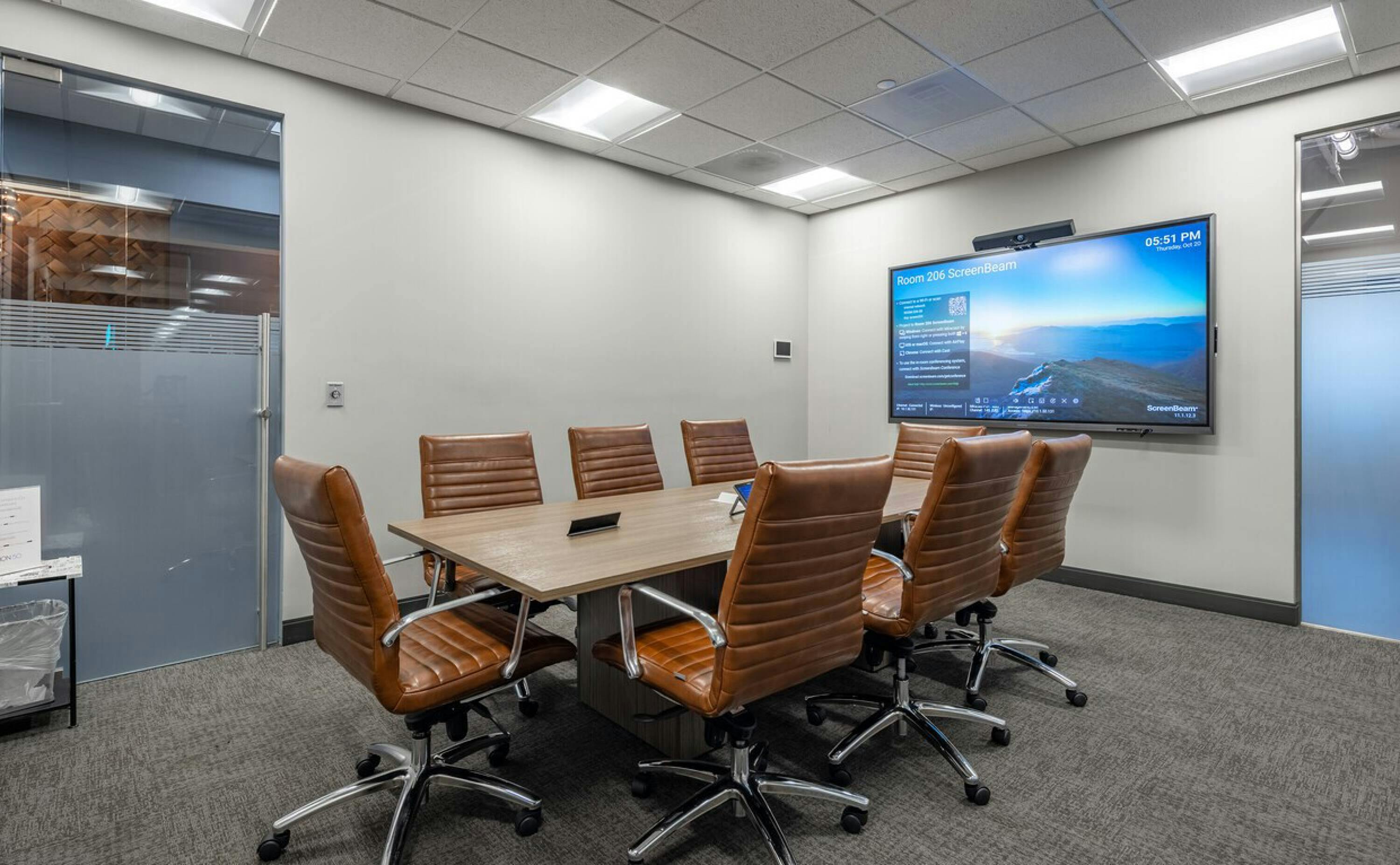 Modern conference room with large table, ideal for corporate meetings and presentations.