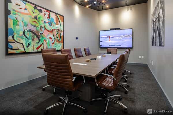 Modern conference room with large table, ergonomic chairs for effective meetings.