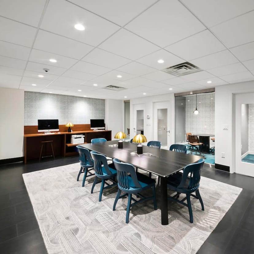 Modern conference room with blue chairs, ideal for meetings and presentations.