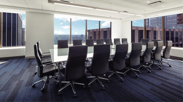 Modern conference room with glass table, ideal for meetings and presentations in Financial District.