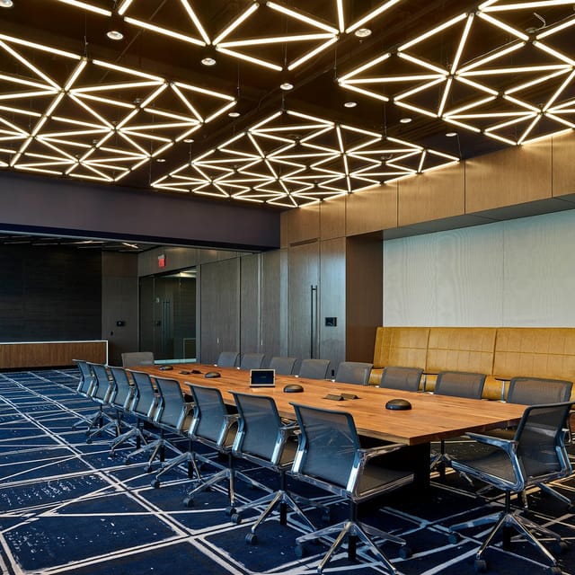 Modern conference room in HQ Newark with ergonomic chairs for meetings and presentations.