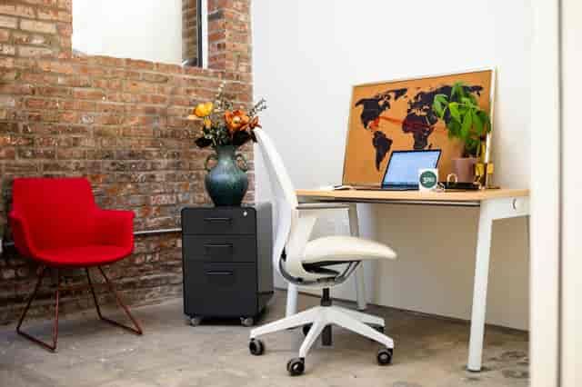 Modern private office with brick wall, ideal for meetings and event planning.